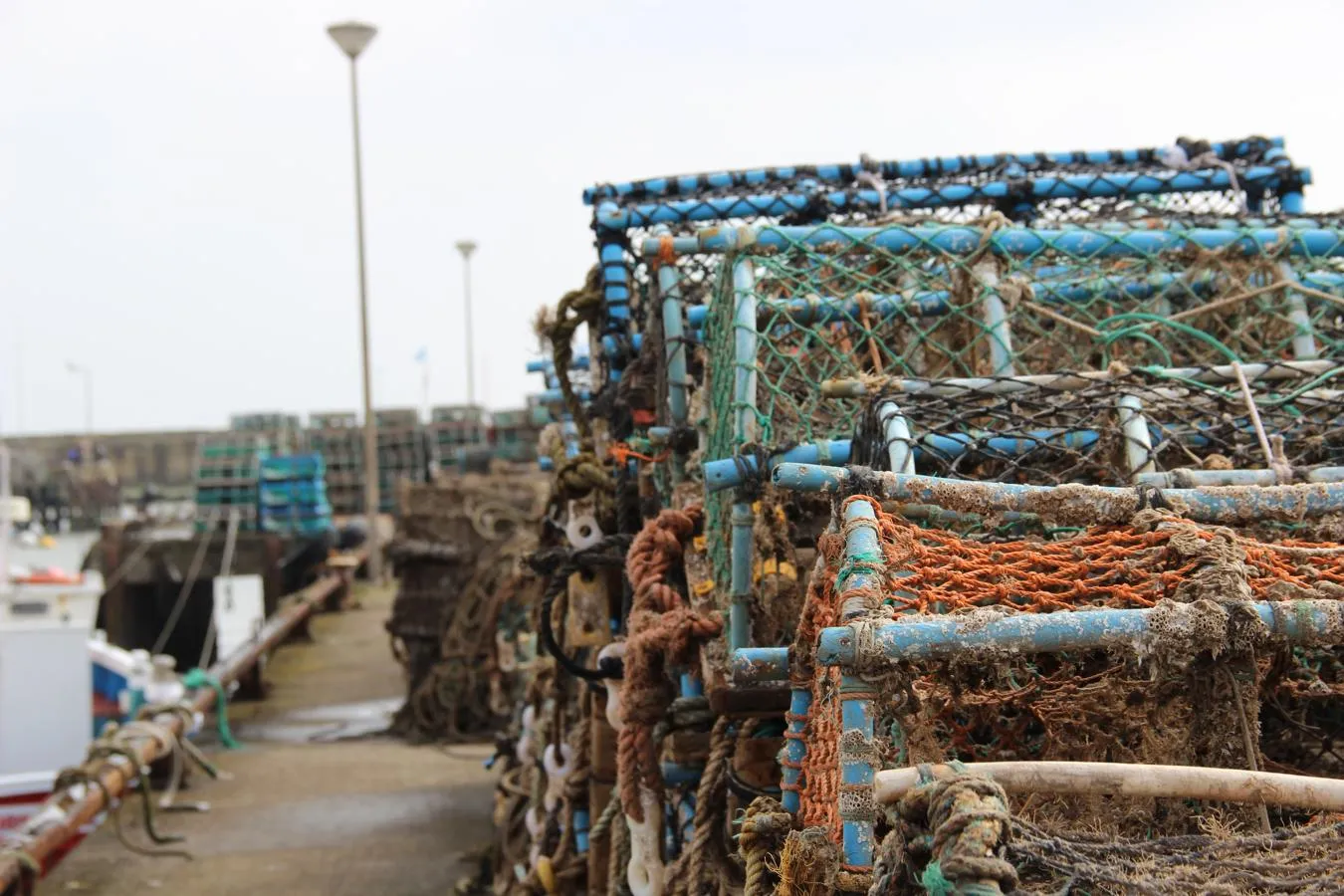 lobster and crab pots stacked along quayside