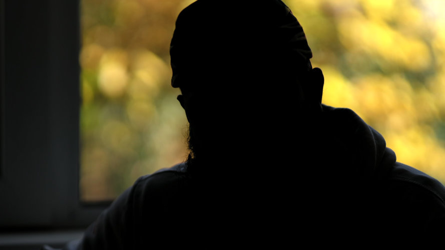 Improving the experience of survivors is a priority. Picture credit: The Salvation Army. silhouetted head and shoulders of a male sitting in front of a window