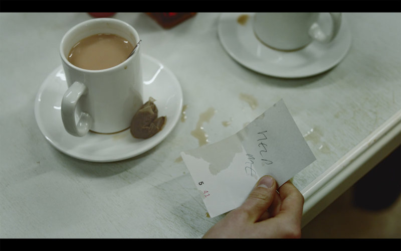 The most prominent form of slavery in the world is labour exploitation with around 27.5 million trapped in this form of slavery globally. Picture credit: The Salvation Army. a mug and saucer on a table with a hand to the side holding a note reading "help me"