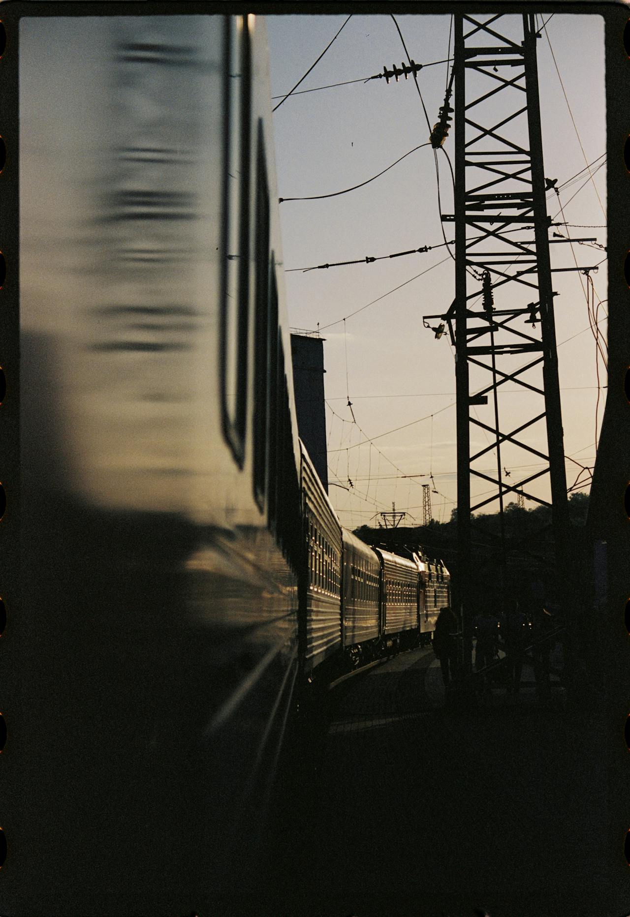 train passing gantry with overhead cables
