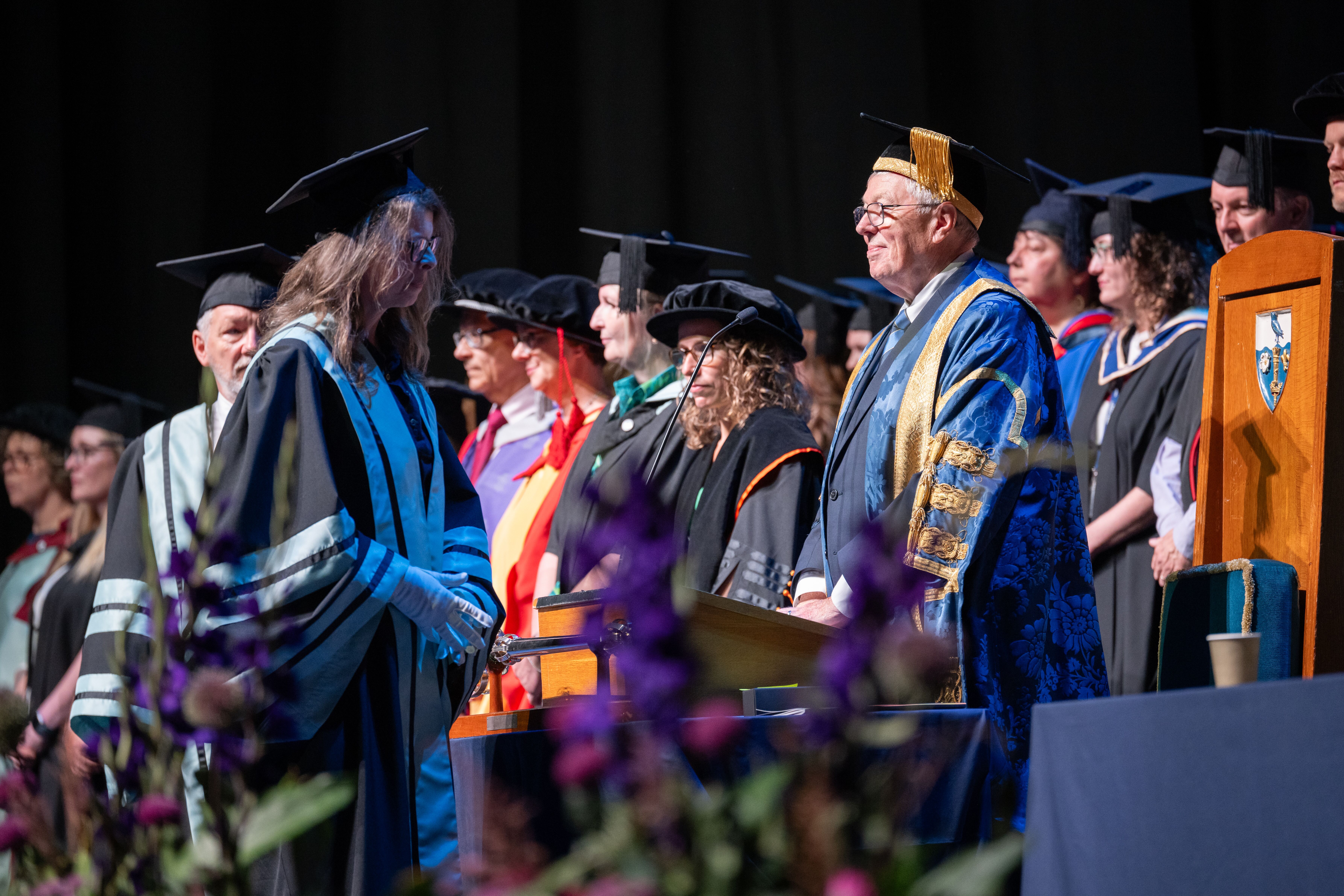 Alan Johnson presiding over a graduation cereomny