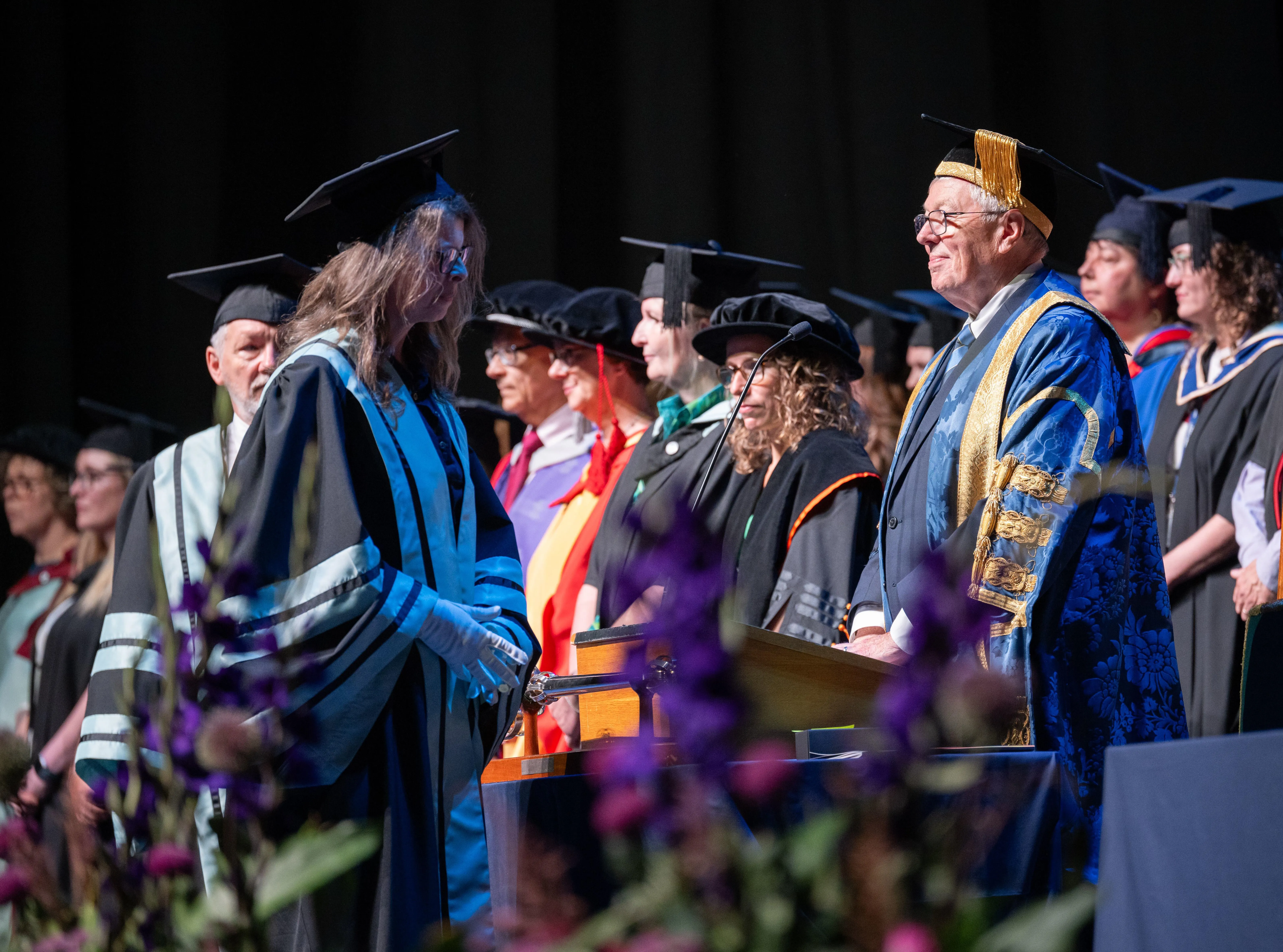 Alan Johnson presiding over a graduation cereomny