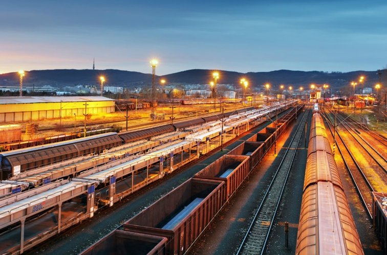 Multiple trains on tracks with goods wagons