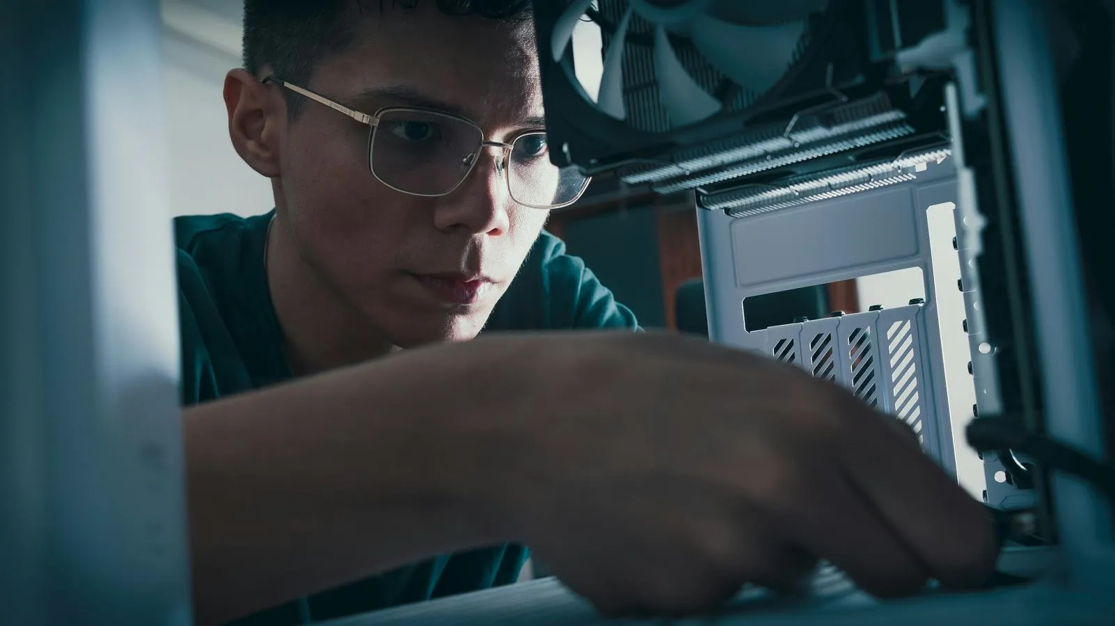 young man in spectacles adjusting scientific equipment
