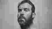 Portrait of bearded man looking sideways at viewer