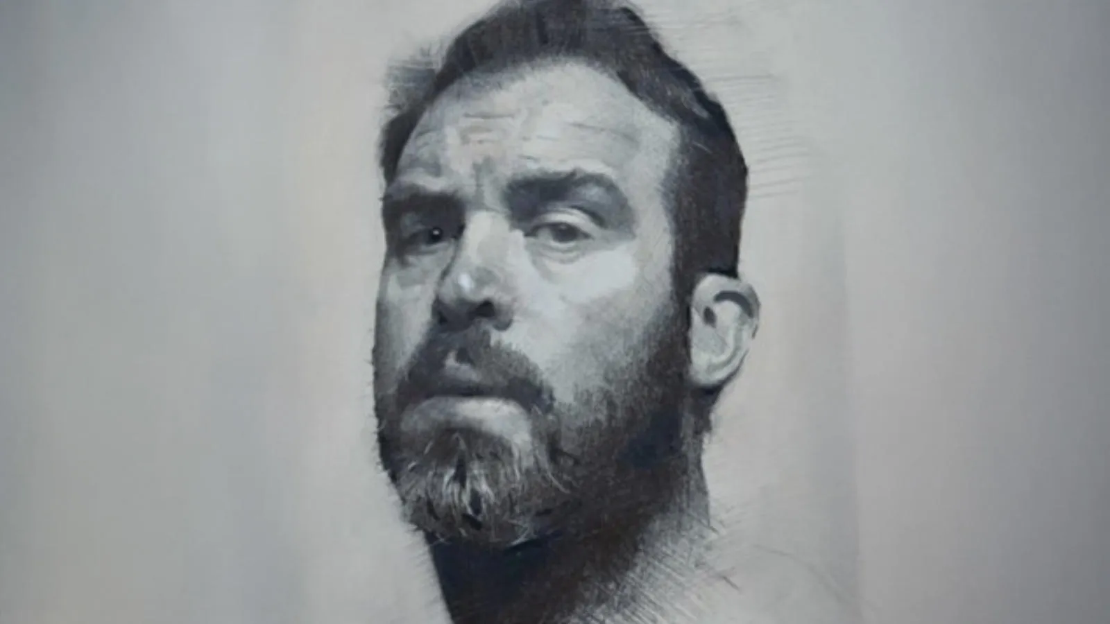 Portrait of bearded man looking sideways at viewer