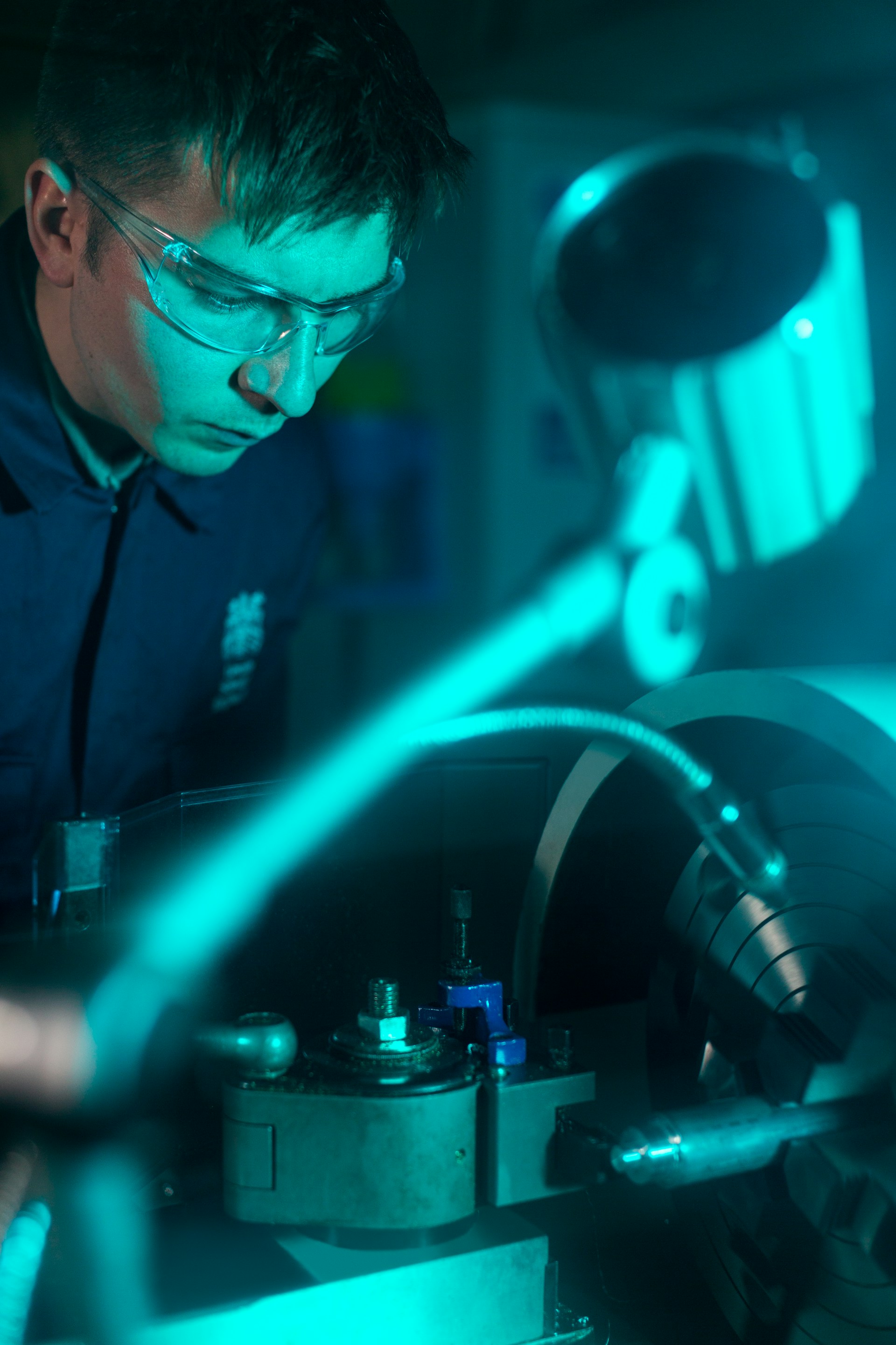 man in protective eyewear operating machinery