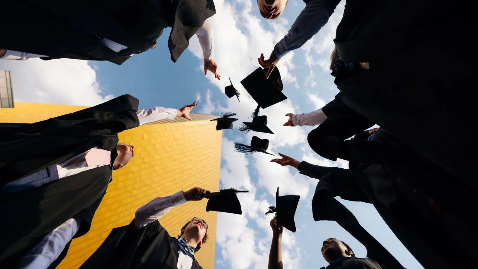 students throwing hat at graduation 