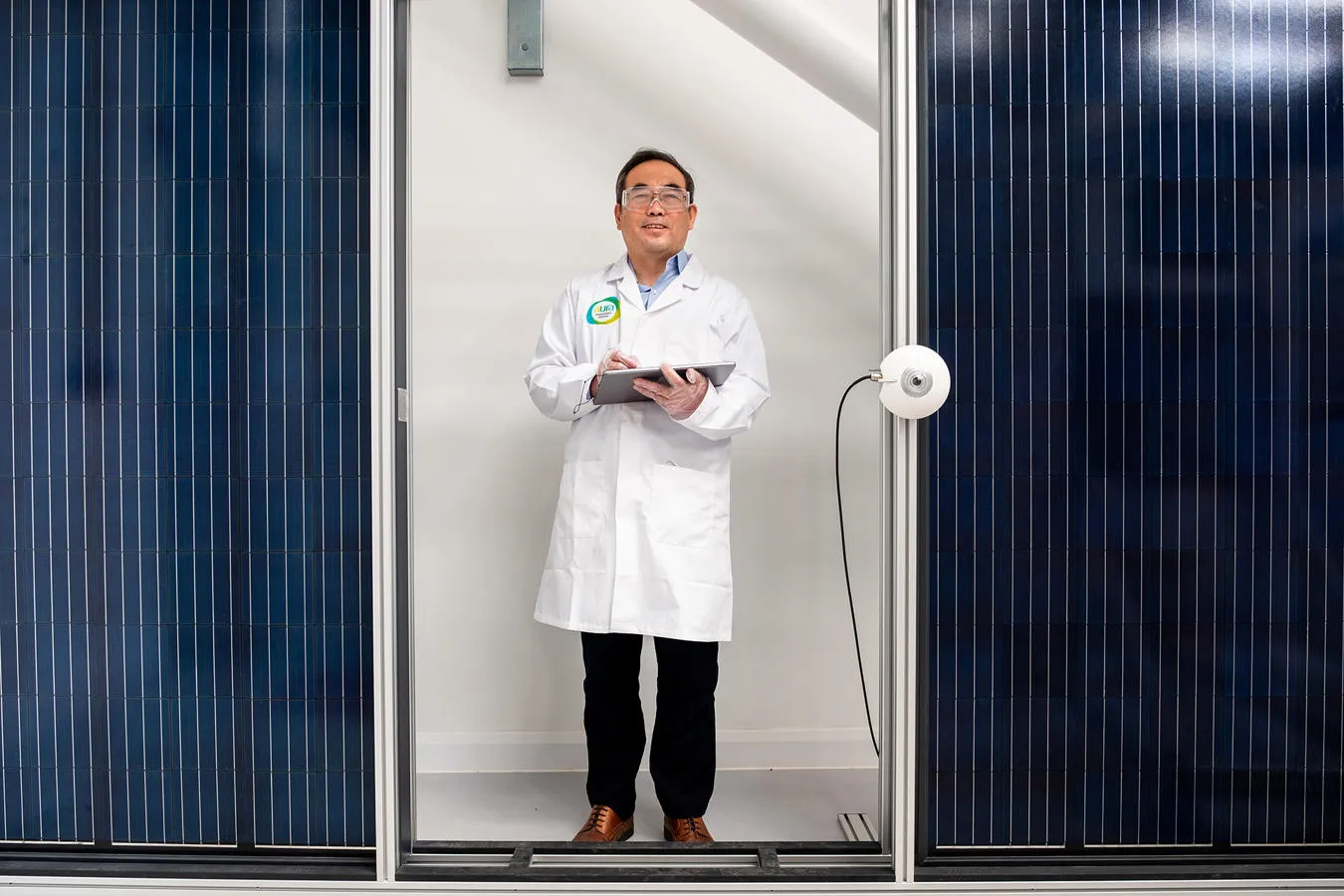 Professor Xudong Zhao next to solar energy panels