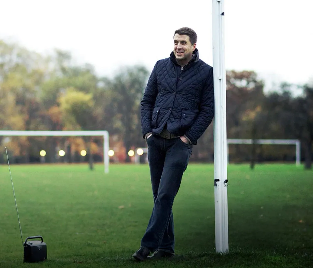 Mark Chapman standing against goal posts on sports field