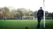Mark Chapman standing against goal posts on sports field