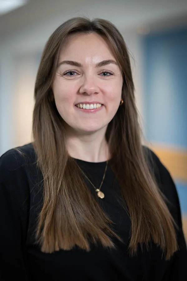 A staff member smiling