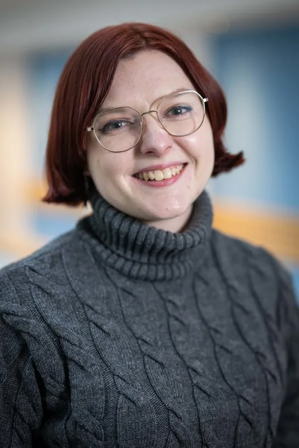 A staff member smiling