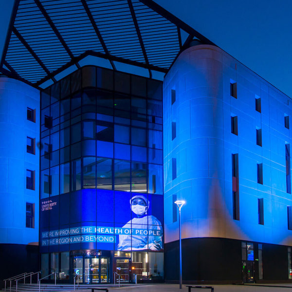 Allam Medical Building lit in blue