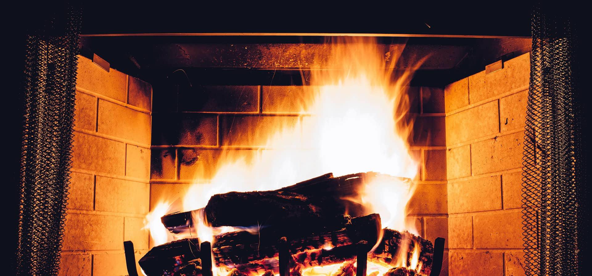 Blazing log fire in a fireplace
