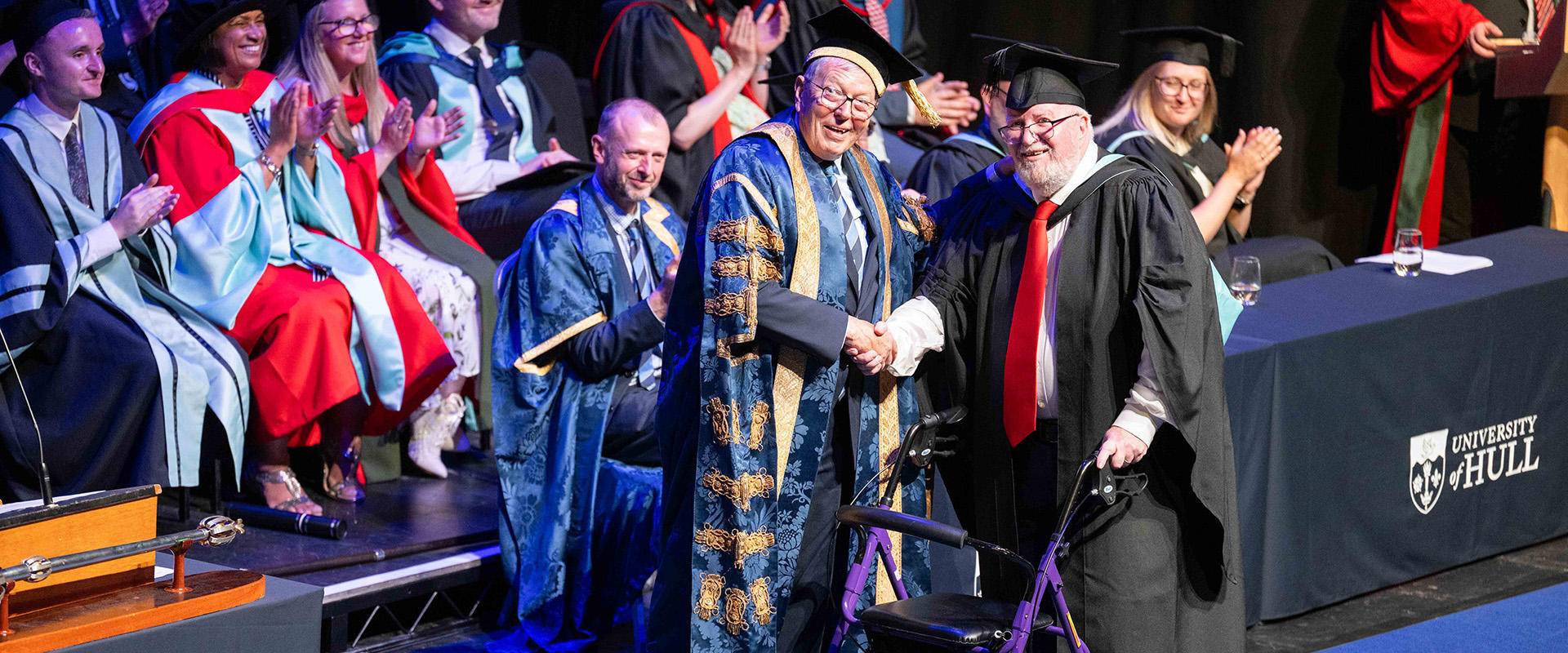 A Hull teaching alumnus walks on stage to receive her honorary degree from the Chancellor