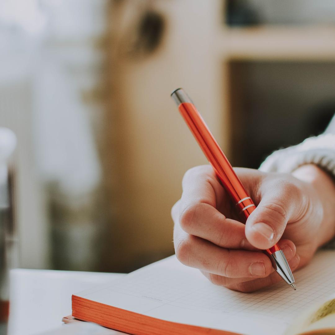 close-up of student writing in diary