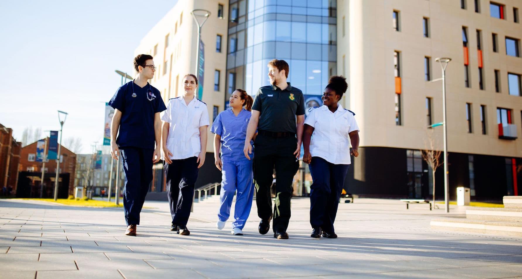 Health Students walking by Allam Medical Building