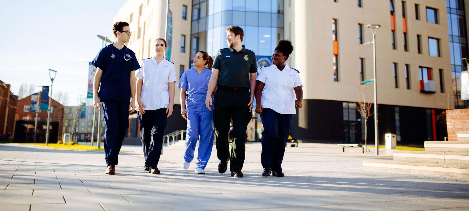Health Students walking by Allam Medical Building