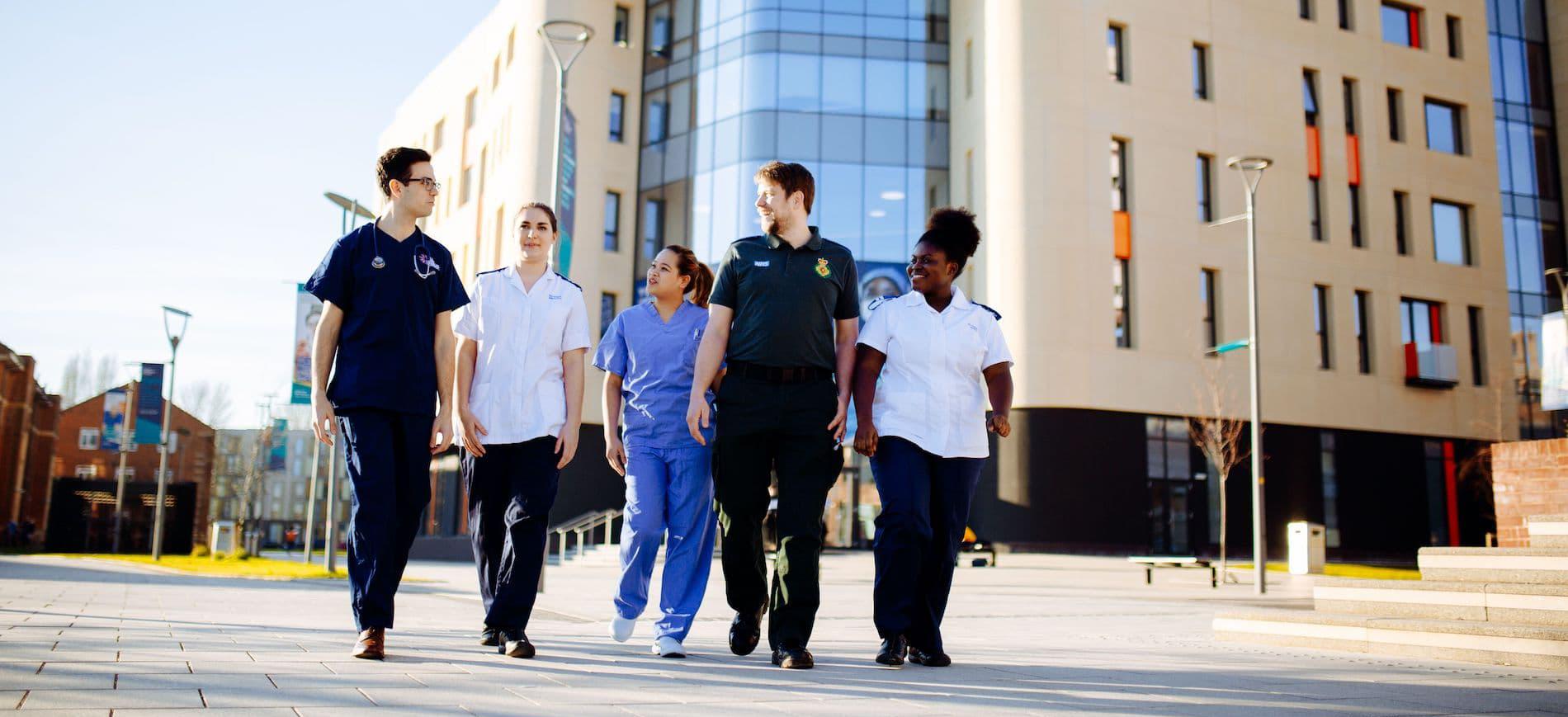 Health Students walking by Allam Medical Building