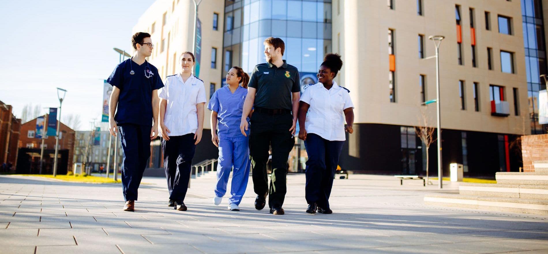 Health Students walking by Allam Medical Building
