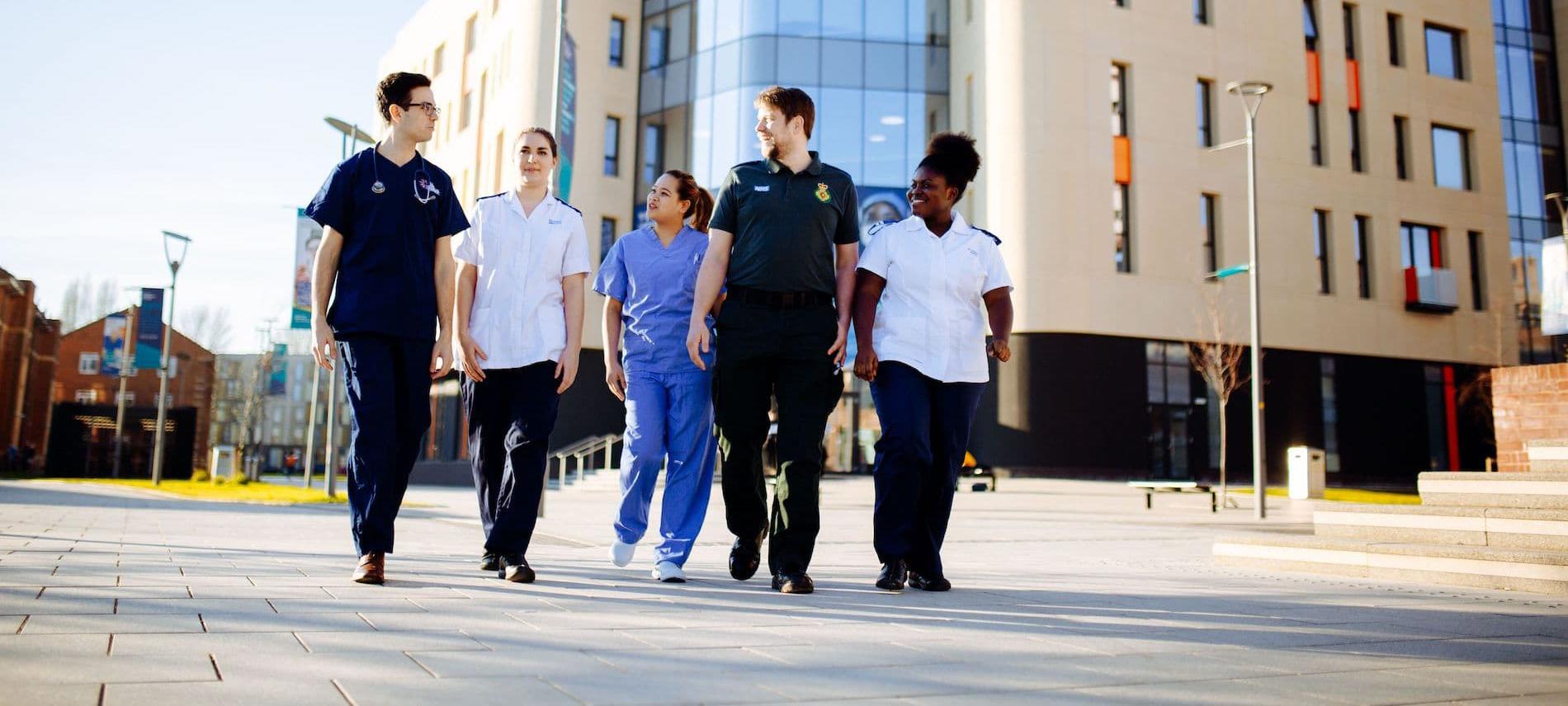 Health Students walking by Allam Medical Building