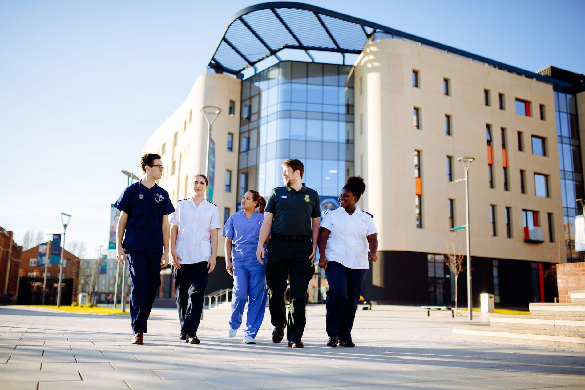 Health Students walking by Allam Medical Building