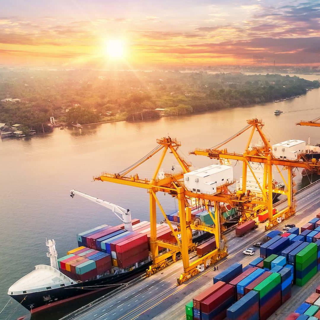 A large ship is loaded with shipping containers in a dock
