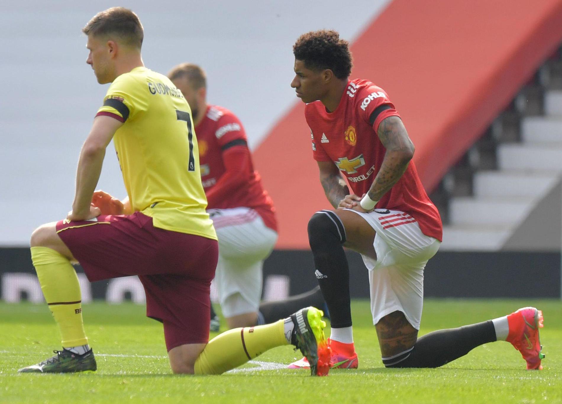 Marcus Rashford taking the knee on the football pitch | Licensed from Alamy