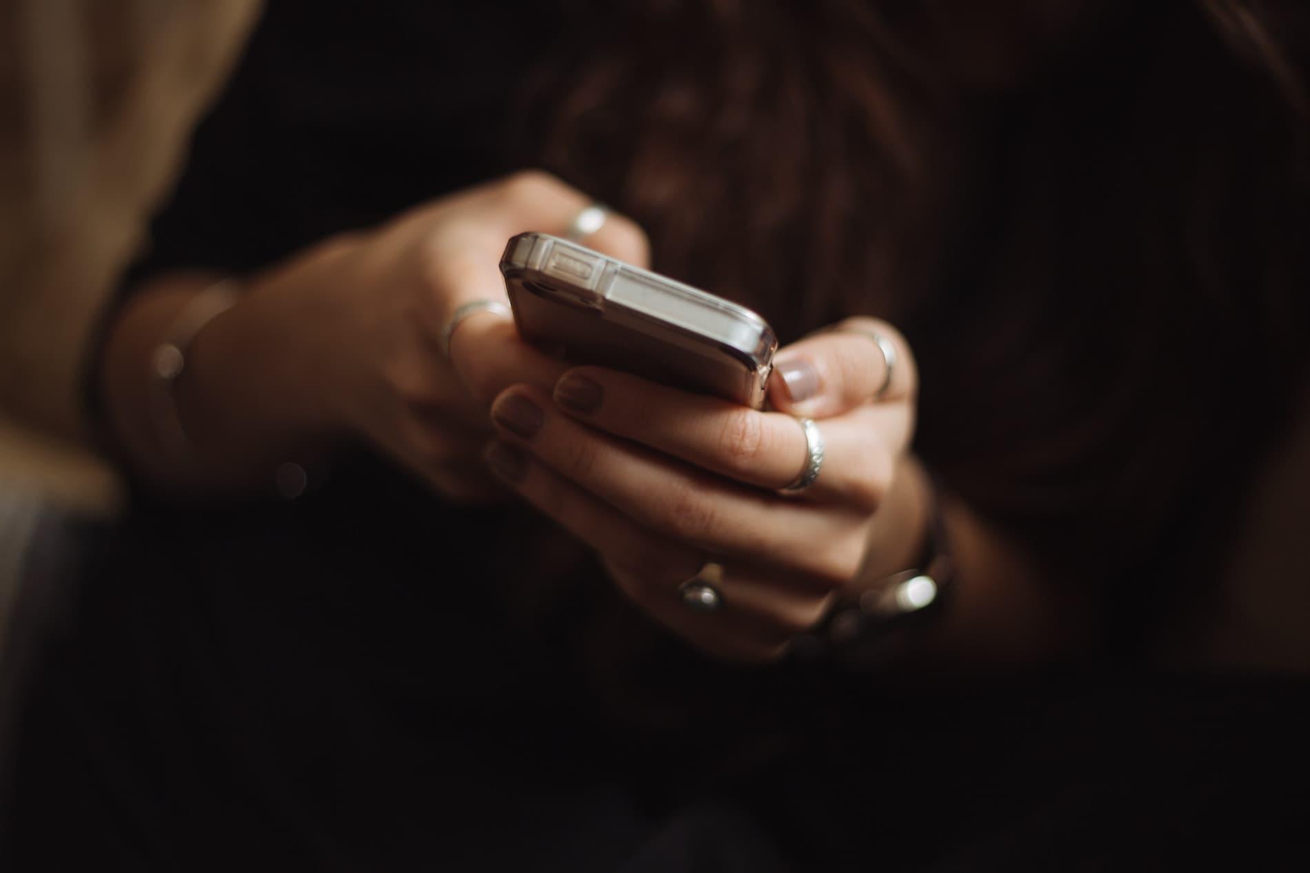 Close up of a person holding a mobile phone in their hands