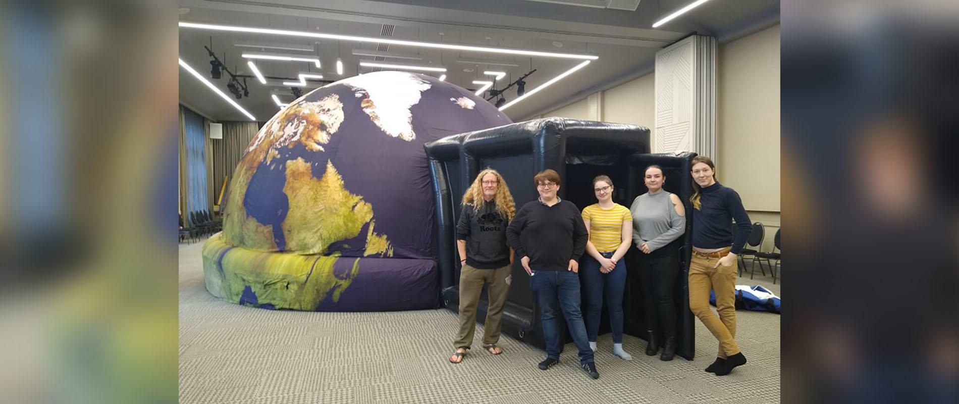 professor brad gibson with students at the new planetarium