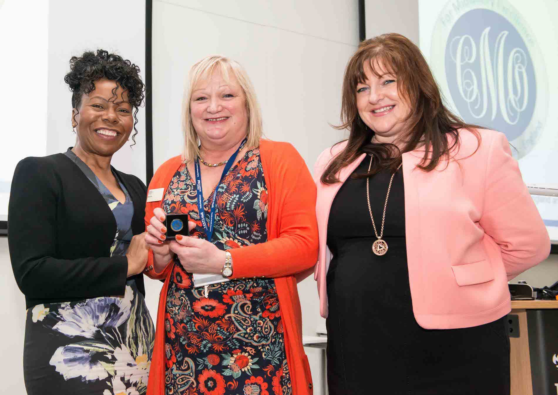 Prof Dunkley-Bent OBE awarding Nicky Clark the Gold Chief Midwifery Officer Award