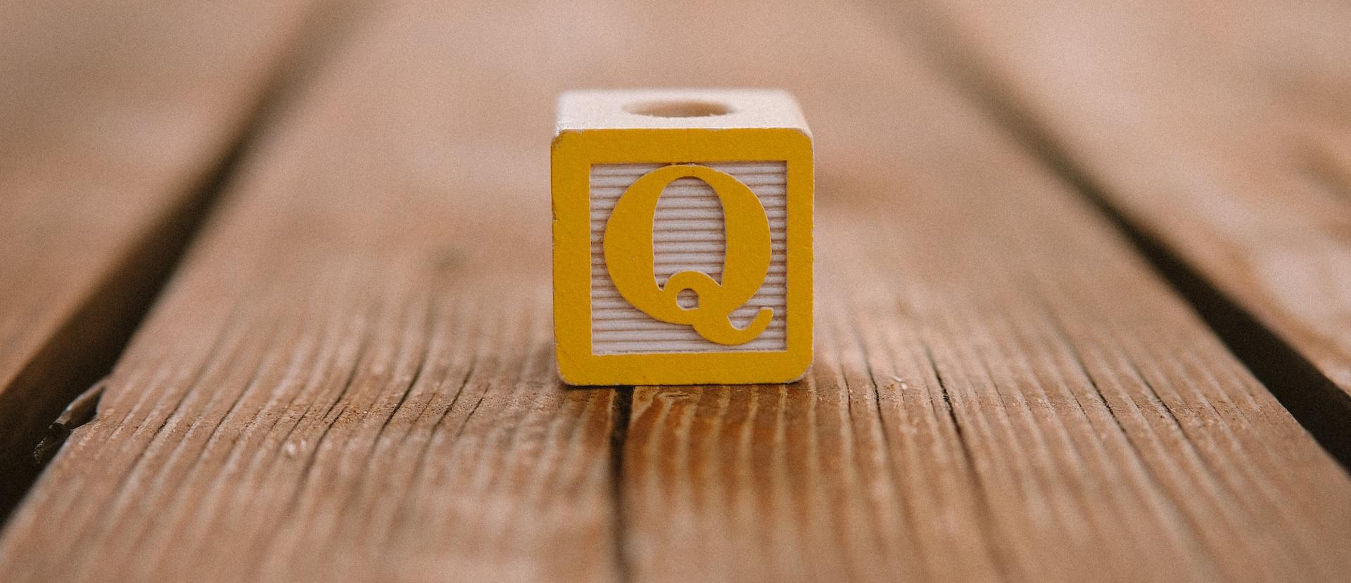 a cube with the letter Q facing forward