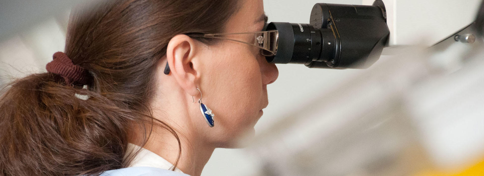 researcher using microscope