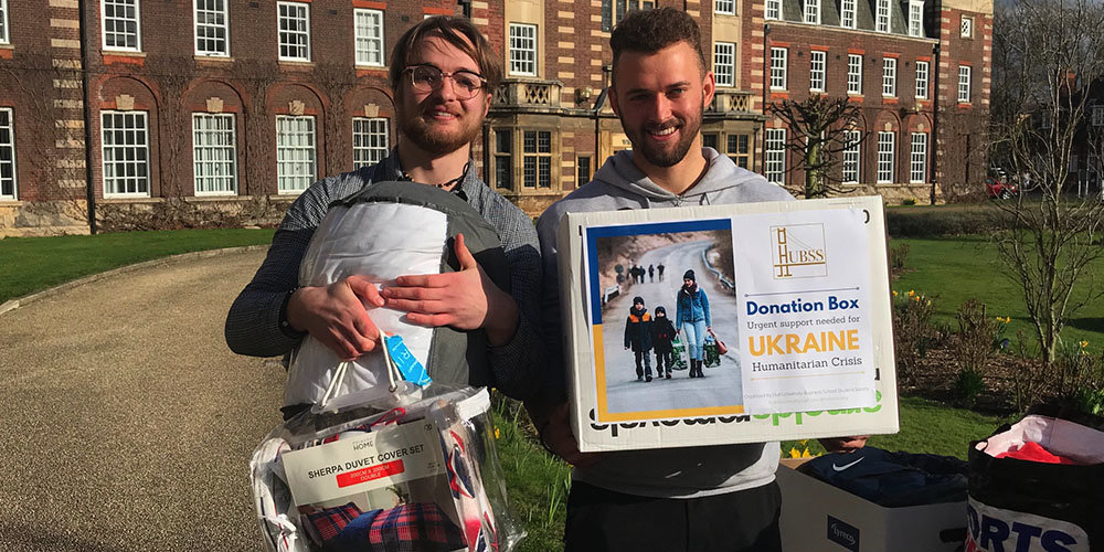 students will forbes and tom bews with donations for ukraine
